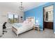Charming bedroom with a bright blue accent wall, chandelier, large window, and en-suite bathroom at 5409 Sedona Dr, Parker, CO 80134