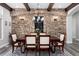 Dining room with a dark wood table, seating for six, and a stone wall with built-in wine racks at 5409 Sedona Dr, Parker, CO 80134