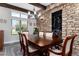 Charming dining room with rustic stone accent wall, chandelier, and a view of the outdoors at 5409 Sedona Dr, Parker, CO 80134