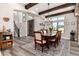 Elegant dining room featuring wood beams, chandelier, rug, and a wooden table and chairs at 5409 Sedona Dr, Parker, CO 80134