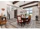 Bright dining room featuring wood beams, a rustic wine barrel, and a long wooden table set on a patterned rug at 5409 Sedona Dr, Parker, CO 80134