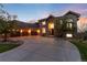 Elegant home exterior with a grand entrance, stone facade, and a spacious driveway at 5409 Sedona Dr, Parker, CO 80134