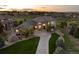 Beautiful home exterior with manicured lawn and long driveway leading up to a stone and stucco facade at 5409 Sedona Dr, Parker, CO 80134