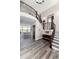 Spacious entryway showcasing hardwood floors, staircase with black iron railings, and a view of the living room at 5409 Sedona Dr, Parker, CO 80134