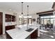 Open concept kitchen with a large island, marble countertops, stainless steel appliances, and modern pendant lighting at 5409 Sedona Dr, Parker, CO 80134