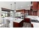 Gourmet kitchen features stainless steel appliances, marble countertops, dark wood cabinets, and a large center island at 5409 Sedona Dr, Parker, CO 80134