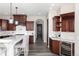 Spacious kitchen featuring dark wood cabinetry, stone countertops, and modern stainless steel appliances at 5409 Sedona Dr, Parker, CO 80134