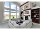 Bright and airy living room with large windows, fireplace, exposed wood beams and built in shelving at 5409 Sedona Dr, Parker, CO 80134