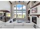 Open-concept living room with high ceilings, fireplace, and a wall of windows providing lots of natural light at 5409 Sedona Dr, Parker, CO 80134