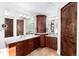 Luxurious main bathroom featuring double vanities, granite counters, and elegant cabinetry at 5409 Sedona Dr, Parker, CO 80134