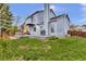 The large backyard includes a deck with a grill and outdoor seating for entertaining at 14430 W Yale Pl, Lakewood, CO 80228