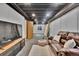 Finished basement featuring a comfortable couch, overhead lighting, and an entertainment center with a television at 14430 W Yale Pl, Lakewood, CO 80228