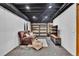 Finished basement with a cozy couch, TV, overhead lighting, and exposed ceiling elements at 14430 W Yale Pl, Lakewood, CO 80228
