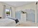 Bright bedroom with a large window and mountain mural feature wall at 14430 W Yale Pl, Lakewood, CO 80228