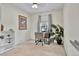 This bedroom features an adjacent desk area, soft carpet, a ceiling fan, and natural light from the exterior window at 14430 W Yale Pl, Lakewood, CO 80228