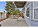 Outdoor deck features seating, a wooden swing, a grill, and a large window at 14430 W Yale Pl, Lakewood, CO 80228