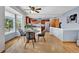 Open dining area with stainless steel appliances and hardwood floors next to the breakfast table at 14430 W Yale Pl, Lakewood, CO 80228