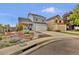 Two-story home with charming curb appeal, a front porch, a two-car garage, and colorful landscaping at 14430 W Yale Pl, Lakewood, CO 80228