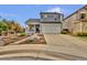 Charming two-story home with a covered front porch, two-car garage, and well-manicured landscaping at 14430 W Yale Pl, Lakewood, CO 80228