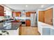 Well-equipped kitchen with stainless steel appliances, granite countertops, and wood cabinetry at 14430 W Yale Pl, Lakewood, CO 80228