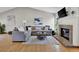 Bright living room featuring a brick fireplace, vaulted ceiling, and comfortable gray sectional sofa at 14430 W Yale Pl, Lakewood, CO 80228