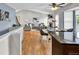 Open-concept living space with hardwood floors, a cozy living room, and a dining area with a view at 14430 W Yale Pl, Lakewood, CO 80228