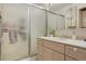 Bathroom featuring a glass door shower, neutral-toned vanity and sink with lots of storage at 3423 S Glencoe St, Denver, CO 80222