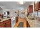 Well-equipped kitchen featuring wood cabinetry, granite counters, and modern appliances at 3423 S Glencoe St, Denver, CO 80222