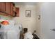 Functional laundry room with washer, dryer, and storage cabinets at 3423 S Glencoe St, Denver, CO 80222