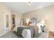 Serene bedroom with plush carpet, ample closet space, and soothing, neutral color scheme at 9758 W Cornell Pl, Lakewood, CO 80227