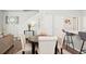 Open dining area featuring seating for four, hardwood floors and modern decor at 6393 N Malaya St, Aurora, CO 80019