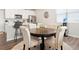Open concept dining area with hardwood floors, a round table, and seating for four at 6393 N Malaya St, Aurora, CO 80019