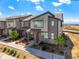 A modern townhome community featuring an appealing exterior design with neutral colors and well-kept landscaping at 6393 N Malaya St, Aurora, CO 80019