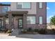 Contemporary townhome featuring a stylish front facade, well-maintained landscaping, and inviting entry way at 6393 N Malaya St, Aurora, CO 80019