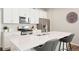 Bright white kitchen featuring stainless steel appliances, a large island and modern finishes at 6393 N Malaya St, Aurora, CO 80019