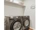 Modern laundry room featuring a side by side Samsung washer and dryer at 6393 N Malaya St, Aurora, CO 80019