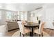 Open-concept living and dining area featuring stylish furnishings, hardwood floors and plenty of natural light at 6393 N Malaya St, Aurora, CO 80019