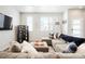 Cozy living room featuring a large sectional sofa, stylish decor, and ample natural light at 6393 N Malaya St, Aurora, CO 80019