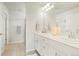 Bright main bathroom with double sinks, white cabinets, and modern fixtures at 6393 N Malaya St, Aurora, CO 80019