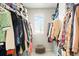 Spacious walk-in closet with organized clothing racks and window for natural light at 6393 N Malaya St, Aurora, CO 80019