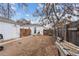 Backyard with detached garage, wooden fence, and dirt ground at 2229 S Bannock St, Denver, CO 80223