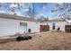 Backyard with detached garage, wooden fence, and dirt ground at 2229 S Bannock St, Denver, CO 80223