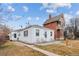 Cozy white single-story home with a charming front porch and seating at 2229 S Bannock St, Denver, CO 80223