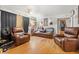 Living room with hardwood floors, leather furniture, and Gathering photos at 2229 S Bannock St, Denver, CO 80223