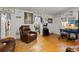 Open living room with hardwood floors, leather furniture, and decorative artwork at 2229 S Bannock St, Denver, CO 80223