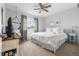 Cozy bedroom with a ceiling fan, large window letting in natural light, and a comfortable bed at 133 Heritage Ave, Castle Rock, CO 80104