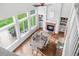 Open-concept dining room with fireplace and many large windows at 133 Heritage Ave, Castle Rock, CO 80104
