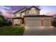 Charming two-story home with a three car garage and well-manicured lawn at 133 Heritage Ave, Castle Rock, CO 80104