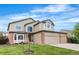 Traditional two-story home with lush lawn, mature landscaping, and a convenient three-car garage at 133 Heritage Ave, Castle Rock, CO 80104