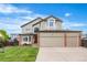 Charming two-story home featuring manicured front lawn, a three car garage, and brick accents at 133 Heritage Ave, Castle Rock, CO 80104